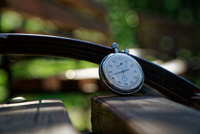 Close-up of stopwatch on bench