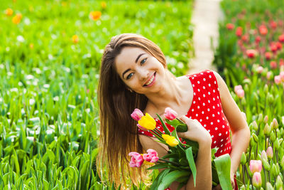 Portrait of smiling young woman on field