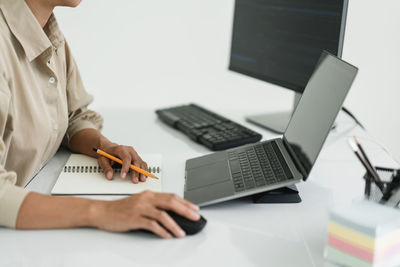 Midsection of woman using laptop