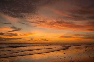 Scenic view of sea against orange sky