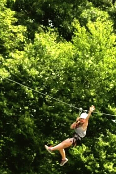 tree, lifestyles, leisure activity, full length, holding, young adult, person, side view, casual clothing, focus on foreground, motion, green color, day, outdoors, mid-air, growth, fun, three quarter length