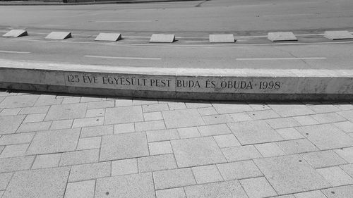 High angle view of text on footpath