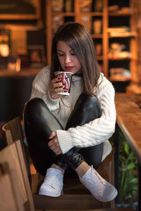 Young woman having coffee at cafe