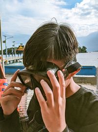 Close-up portrait of a boy drinking water