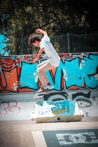 Side view of man jumping on slide