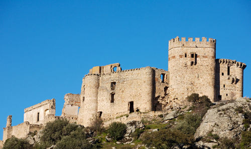 Low angle view of historic building against blue sky