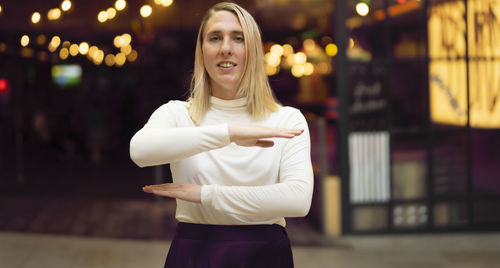 Portrait of a smiling young woman standing outdoors