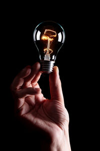 Close-up of light bulb against black background