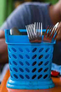 Close-up of hand holding blue table