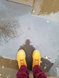 Low section of man standing on water