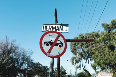 Low angle view of road sign against sky