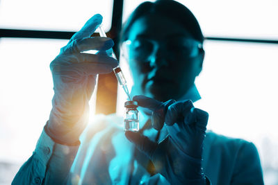 Midsection of man holding syringe