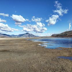 Scenic view of beach against blue sky