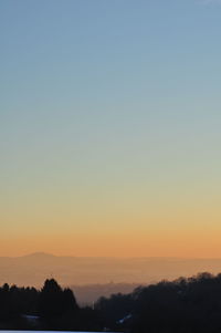 Scenic view of silhouette landscape against clear sky during sunset