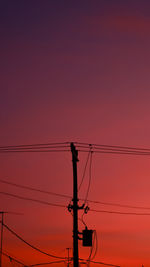 Low angle view of silhouette electricity pylon against romantic sky