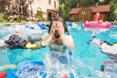 High angle view of shirtless man in swimming pool