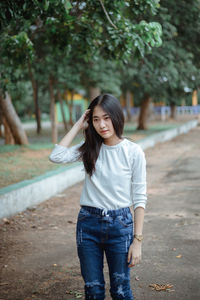 Smiling young woman standing outdoors