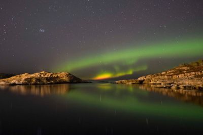Scenic view of lake against sky at night