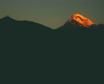 Scenic view of silhouette mountains against clear sky