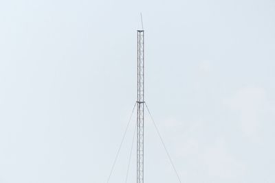 Low angle view of electricity pylon against clear sky