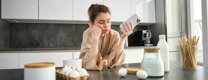 Young woman drinking coffee at home