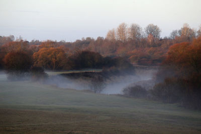 Scenic view of waterfall against sky during autumn