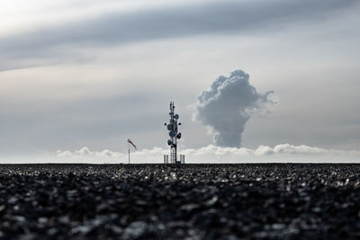 Low angle view of communications tower against sky