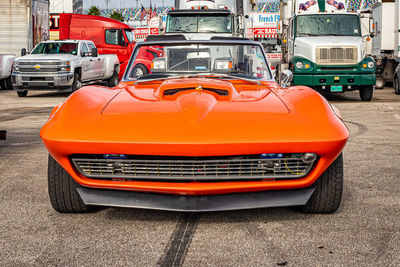 Close-up of orange car on road