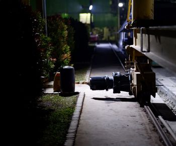 View of illuminated railroad tracks by street at night