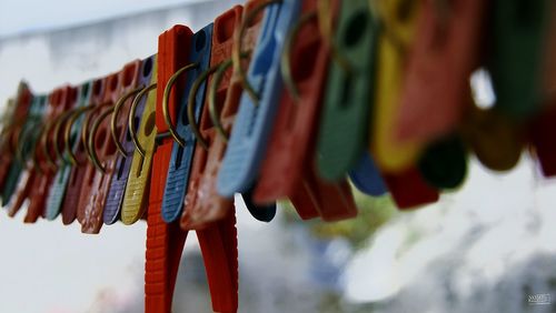 Low angle view of colorful umbrellas hanging against sky