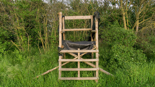 Wooden chair on grassy field