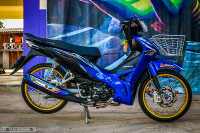 Side view of multi colored bicycle parked on street