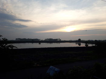 Scenic view of lake against sky during sunset