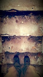 Low section of man standing on puddle