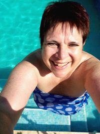 Portrait of a smiling young woman in swimming pool