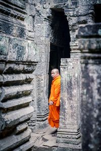 Full length of a man standing at temple outside building