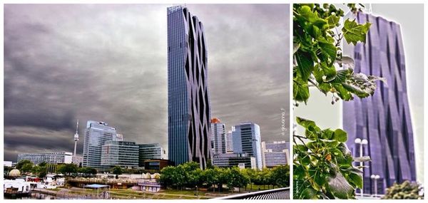 Buildings in city against cloudy sky