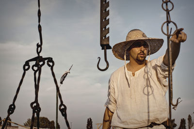 Man wearing hat while standing outdoors