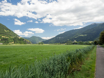 Scenic view of field and mountains against sky