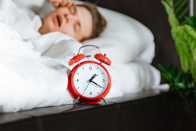 Midsection of woman sleeping on bed