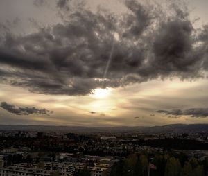 Cityscape against cloudy sky