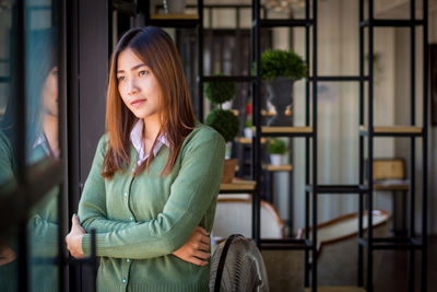 Portrait of beautiful young woman looking away