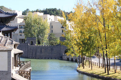 Scenic view of river by buildings in city