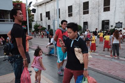 People standing on street in city