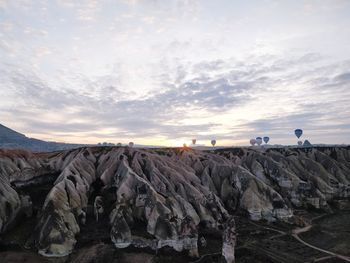 Scenic view of rock formations against sky during sunset