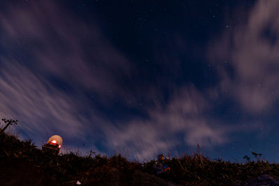 Low angle view of silhouette trees against sky at night