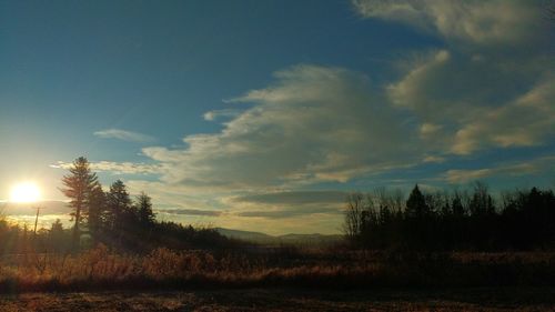 Scenic view of landscape against sky at sunset