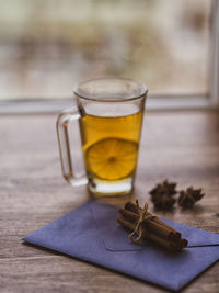 Cup of lemon hot tea honey and cinnamon stick on envelope with message with dried star anise