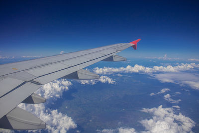 Aerial view of airplane flying in sky