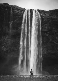 Man at waterfall in iceland